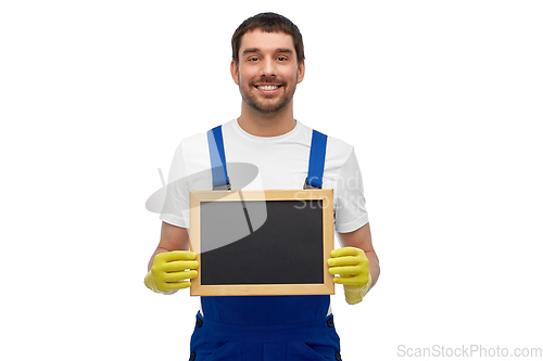 Image of smiling worker or male cleaner showing chalkboard