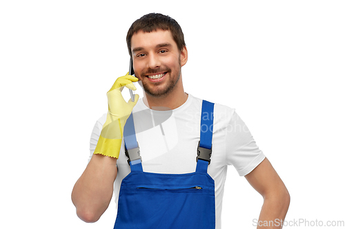 Image of happy male worker or cleaner calling on smartphone