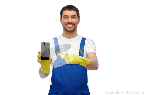 Image of happy male worker or cleaner showing smartphone