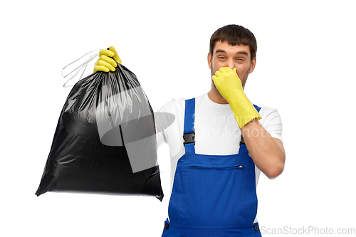 Image of male worker or cleaner with stinky garbage bag