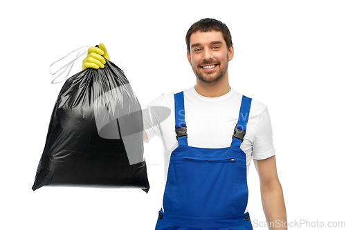 Image of happy male worker or cleaner showing garbage bag