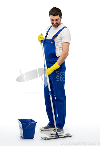 Image of male cleaner cleaning floor with mop and bucket