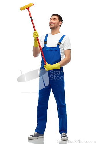 Image of male cleaner in overall with window cleaning mop