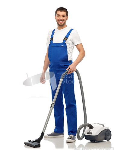 Image of male worker cleaning floor with vacuum cleaner