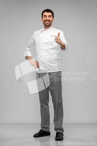 Image of smiling male chef in jacket showing thumbs up
