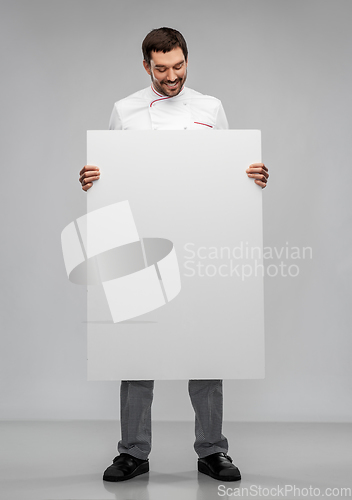 Image of happy smiling male chef with big white board