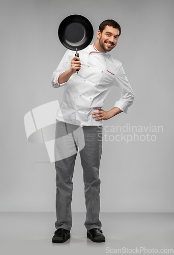 Image of happy smiling male chef in jacket with frying pan