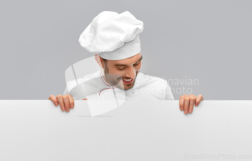 Image of happy smiling male chef with big white board