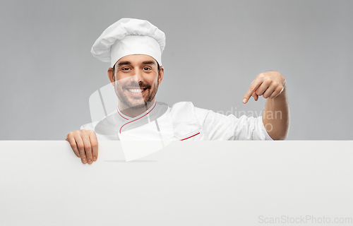 Image of happy smiling male chef with big white board