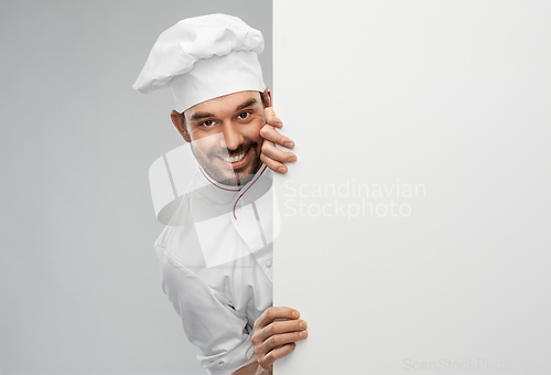 Image of happy smiling male chef with big white board