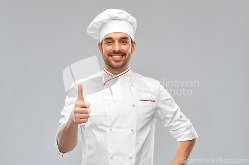 Image of smiling male chef in toque showing thumbs up