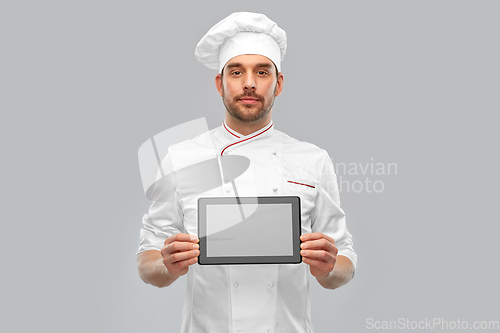Image of male chef showing tablet pc computer