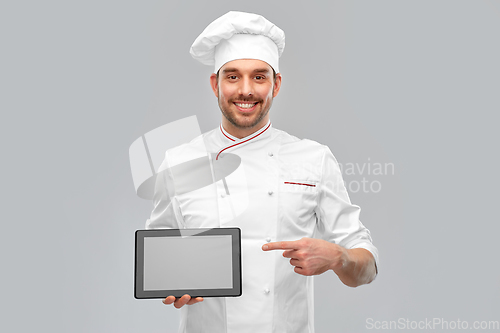 Image of happy smiling male chef showing tablet pc computer