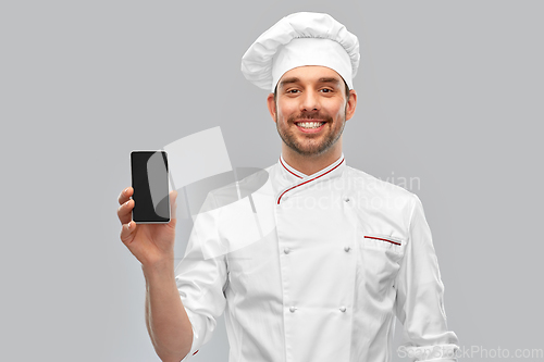 Image of happy smiling male chef showing smartphone