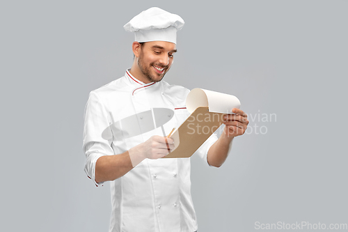 Image of happy smiling male chef with clipboard
