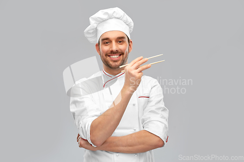 Image of happy smiling male chef with chopsticks