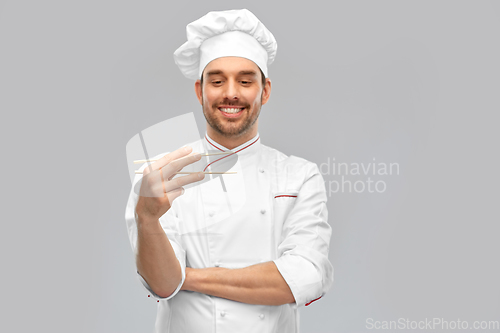 Image of happy smiling male chef with chopsticks