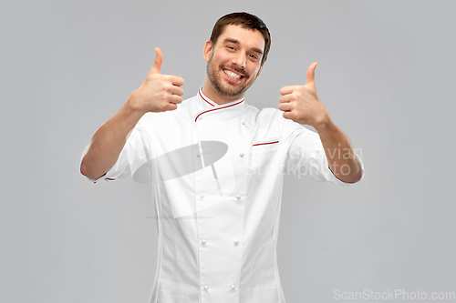 Image of smiling male chef in jacket showing thumbs up