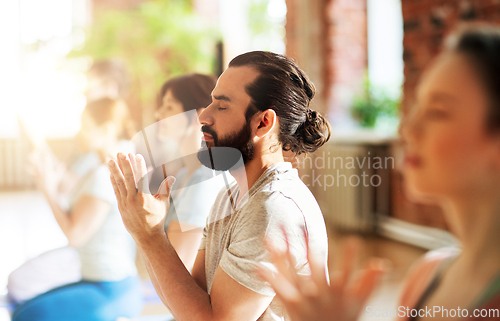 Image of group of people meditating at yoga studio