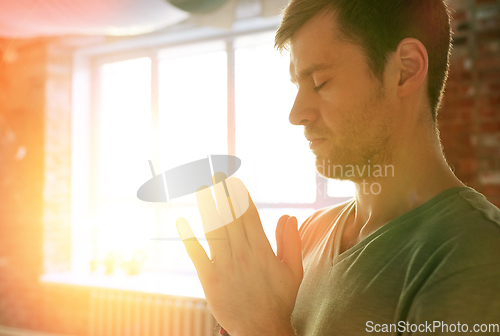 Image of close up of man meditating at yoga studio