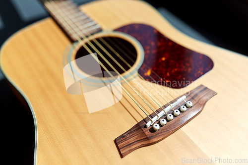 Image of close up of acoustic guitar on window sill