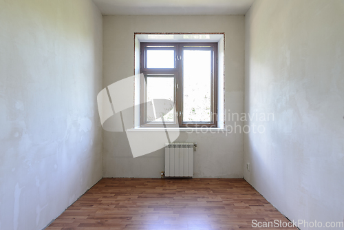 Image of View of the window in a small room, the room has a laminate