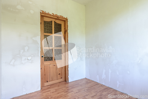 Image of View of the front door in a small room with a fine finish after renovation