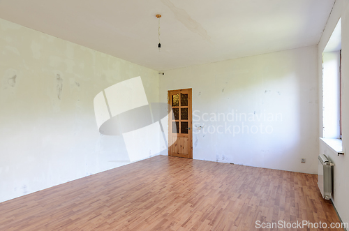 Image of A fragment of the interior of a spacious room with a fine finish, view of the front door