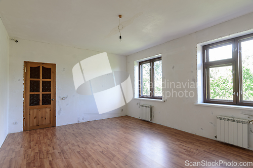 Image of A fragment of a room with a fine finish, a view of the front door and windows