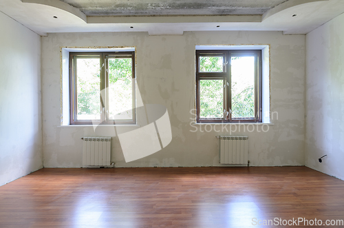 Image of Interior of empty room during renovation, wall view with windows