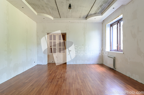 Image of The interior of an empty room with a fine renovation, a laminate is laid on the floor