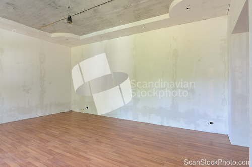 Image of Interior of an empty room after renovation, gray walls, laminate flooring on the floor