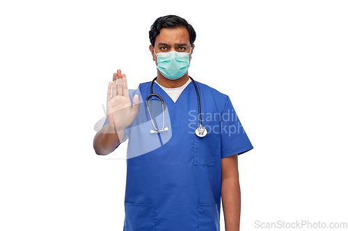 Image of indian male doctor mask showing stop gesture