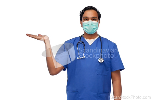 Image of indian male doctor in blue uniform and mask