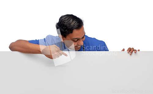 Image of smiling male doctor or nurse with big white board