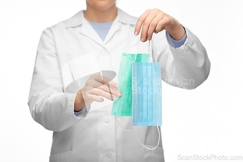 Image of female doctor showing two medical masks