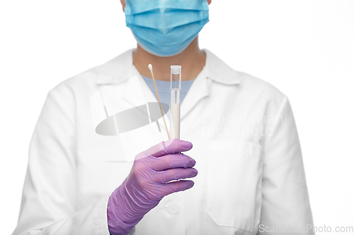 Image of female doctor with test tube and cotton swab