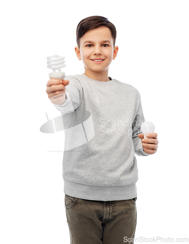 Image of smiling boy comparing different light bulbs