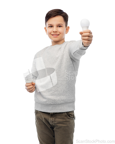 Image of smiling boy comparing different light bulbs