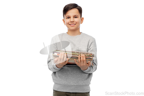 Image of smiling boy with magazines sorting paper waste