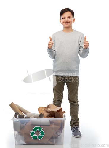 Image of smiling boy sorting paper waste showing thumbs up