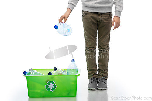 Image of boy throwing plastic bottle into box