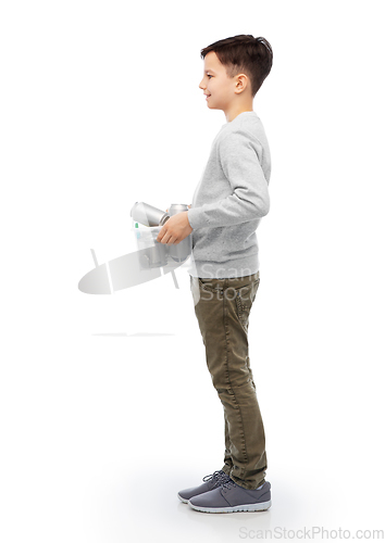 Image of smiling boy sorting metallic waste