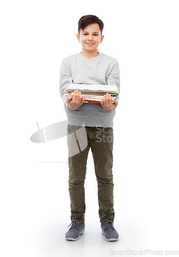 Image of smiling boy with magazines sorting paper waste