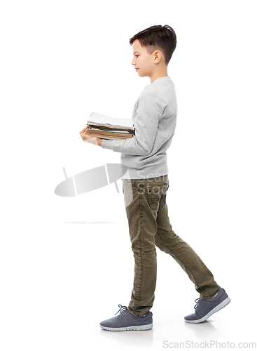 Image of smiling boy with magazines sorting paper waste