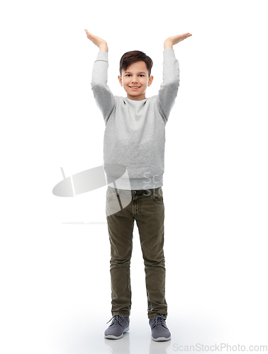 Image of happy smiling boy holding something imaginary