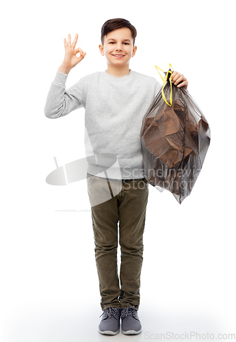 Image of smiling boy with paper garbage in plastic bag