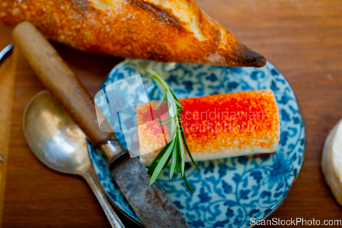 Image of French cheese and fresh  baguette on a wood cutter