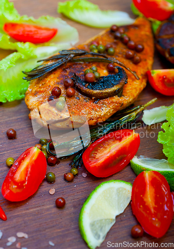 Image of wood fired hoven cooked chicken breast on wood board