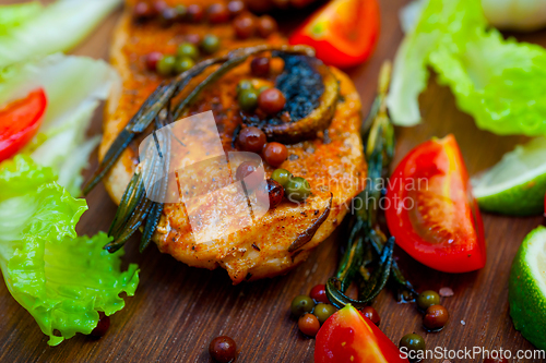 Image of wood fired hoven cooked chicken breast on wood board